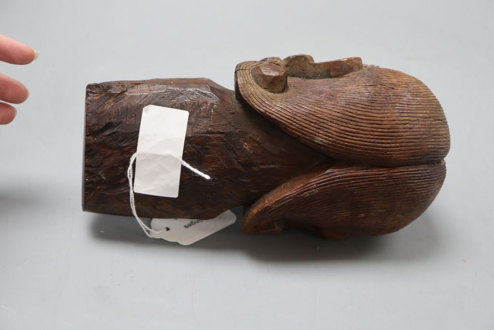 An Oriental carved hardwood head of immortal, with glass eyes, height 22cm
